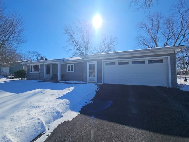 single story home featuring driveway and an attached garage