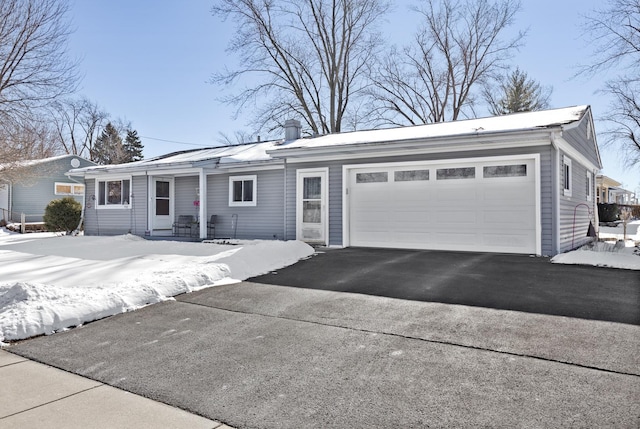 ranch-style home featuring a garage and driveway