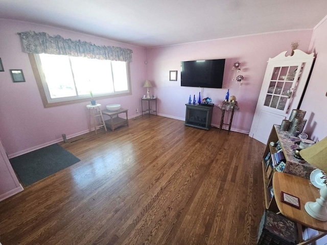 living area featuring dark wood-type flooring and baseboards