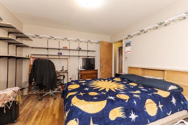 bedroom featuring wood finished floors