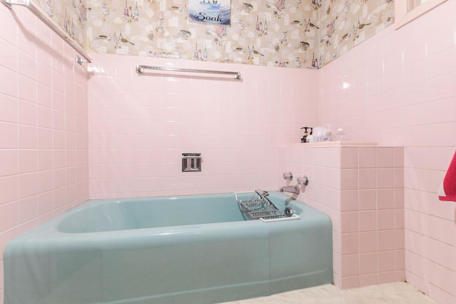 full bathroom with a garden tub, tile walls, and wallpapered walls