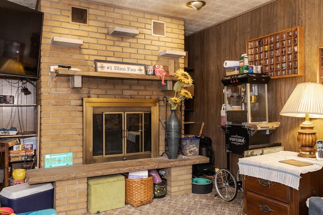 living area with visible vents and wood walls