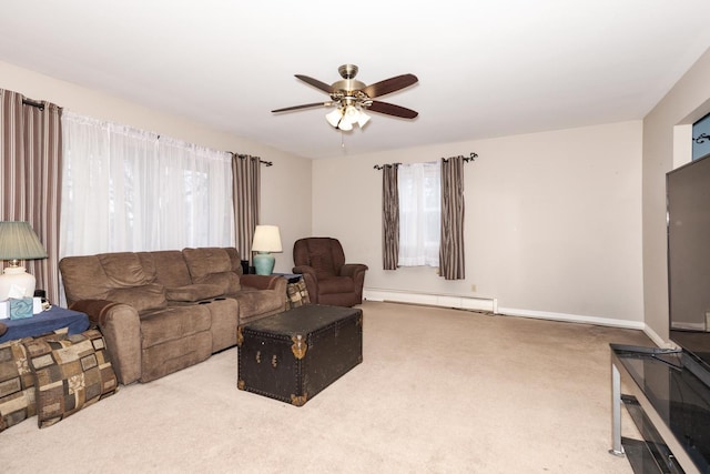 living area with carpet, a baseboard radiator, baseboards, and ceiling fan