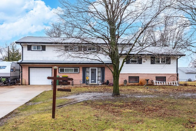 view of front of home with a garage, concrete driveway, brick siding, and a front lawn