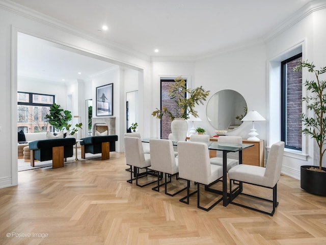 dining area featuring a fireplace, ornamental molding, and recessed lighting