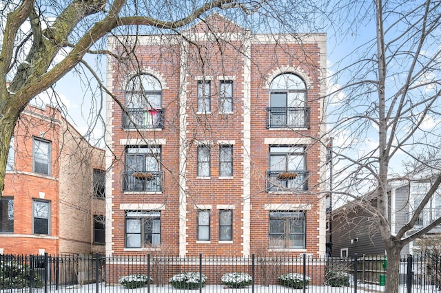 view of building exterior with a fenced front yard