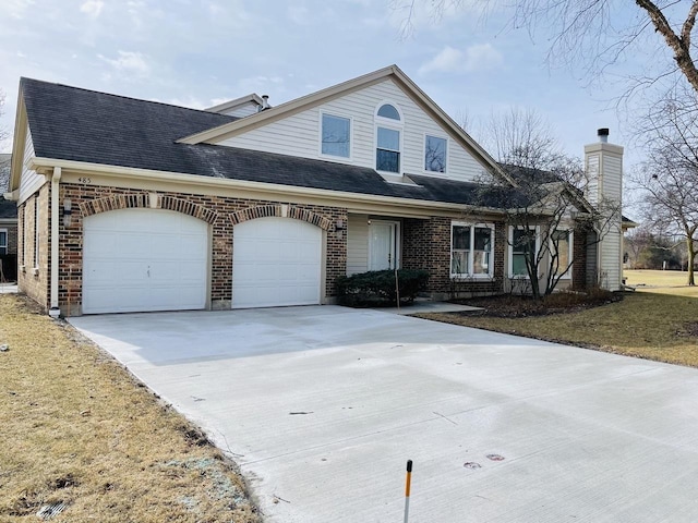 view of front of home with a garage, concrete driveway, brick siding, and roof with shingles