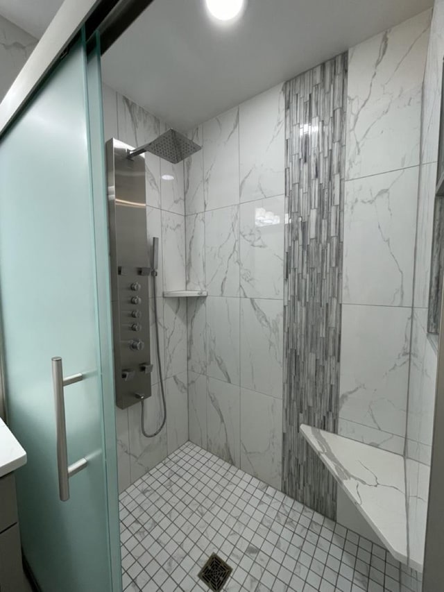 bathroom featuring a stall shower and vanity