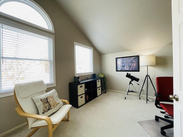 office space with lofted ceiling, light carpet, and baseboards