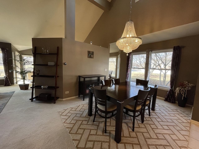 dining room featuring an inviting chandelier, a high ceiling, baseboards, and light colored carpet