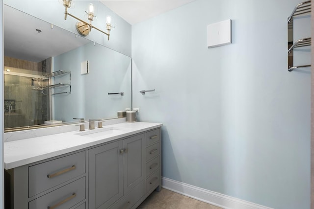 full bathroom featuring tile patterned flooring, vanity, baseboards, and an enclosed shower