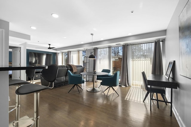 living room with dark wood-style floors, recessed lighting, and baseboards