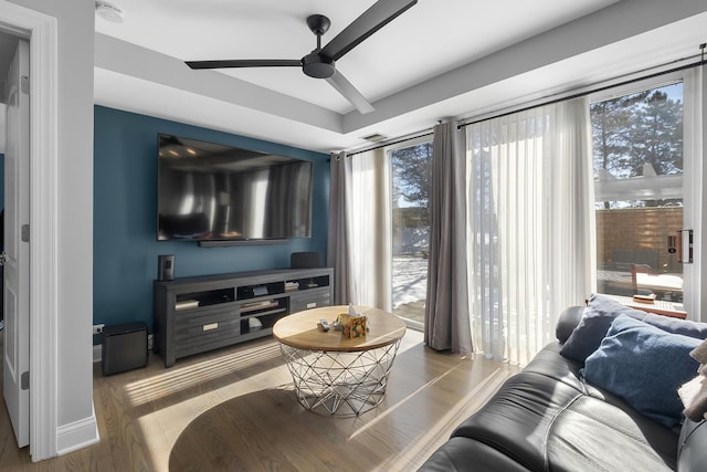 living room with a healthy amount of sunlight, ceiling fan, baseboards, and wood finished floors