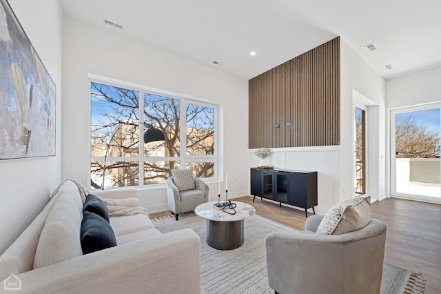 living room with baseboards, recessed lighting, visible vents, and light wood-style floors