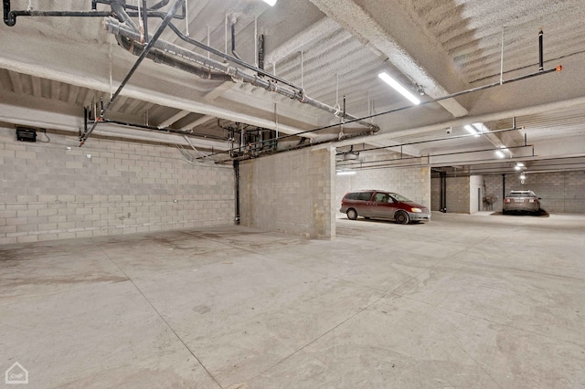 parking garage with concrete block wall and a garage door opener