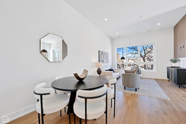 dining area with light wood finished floors, baseboards, and recessed lighting