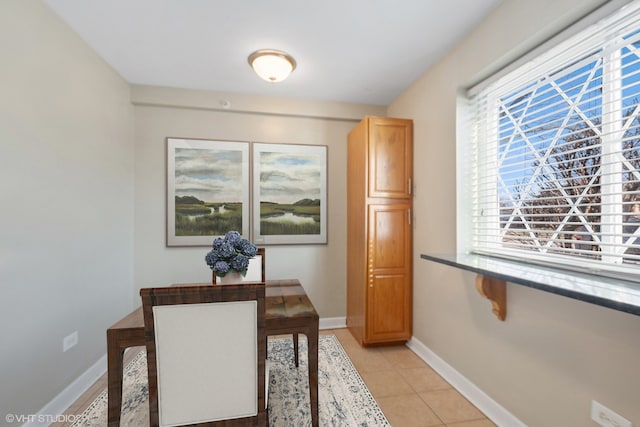 home office featuring baseboards and light tile patterned flooring