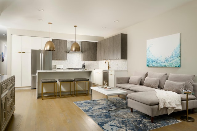 living room with light wood-style floors and recessed lighting