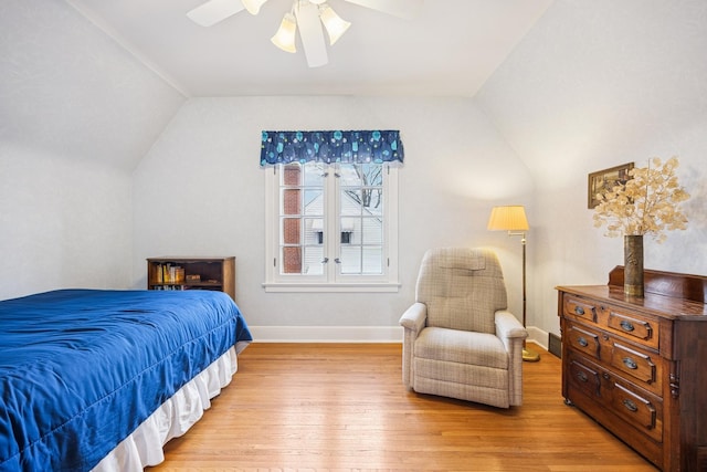 bedroom with light wood-type flooring, ceiling fan, baseboards, and vaulted ceiling