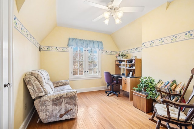 office space with a ceiling fan, baseboards, light wood-type flooring, and lofted ceiling