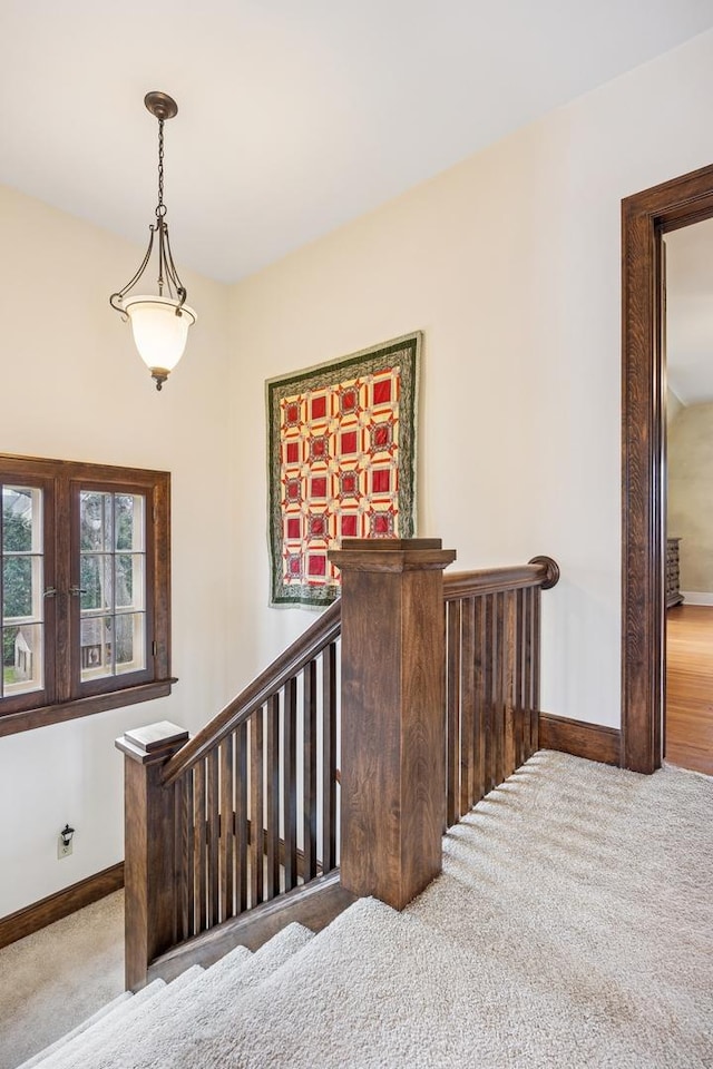 staircase with carpet floors and baseboards