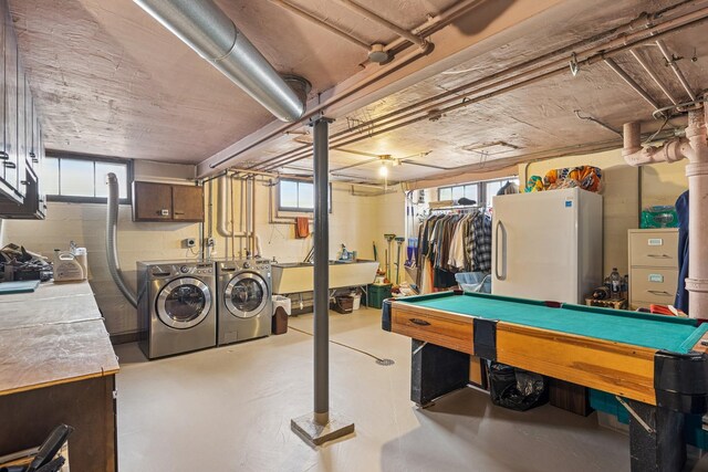 interior space with independent washer and dryer, freestanding refrigerator, billiards, and concrete block wall