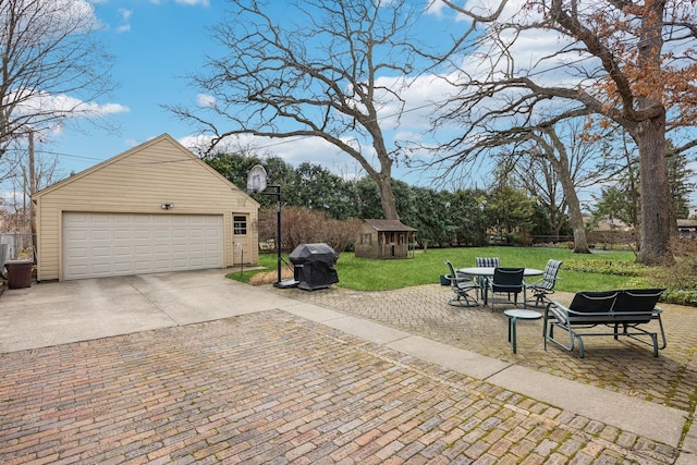 exterior space with a detached garage, an outdoor structure, and a lawn