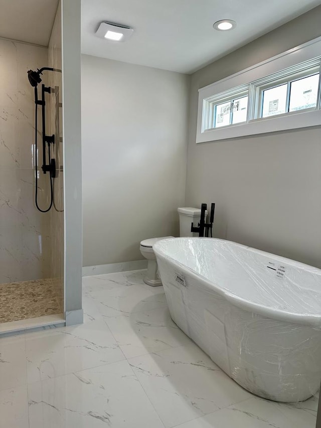 bathroom with marble finish floor, a marble finish shower, recessed lighting, a soaking tub, and baseboards