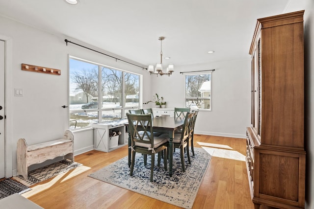 dining area with light wood-style floors, baseboards, a chandelier, and recessed lighting