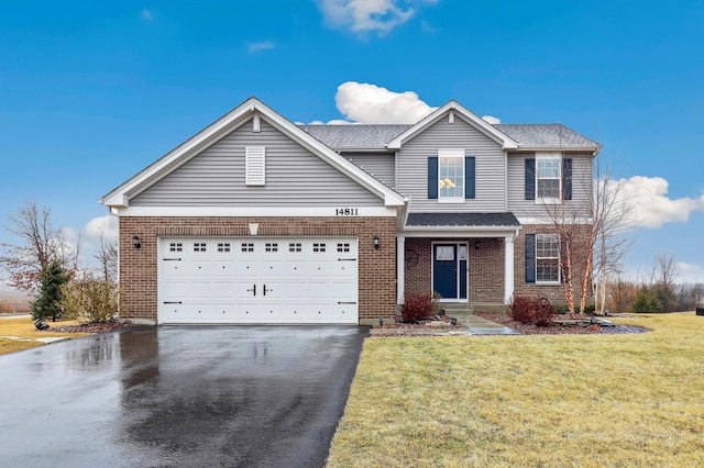 traditional home featuring aphalt driveway, a garage, brick siding, and a front lawn