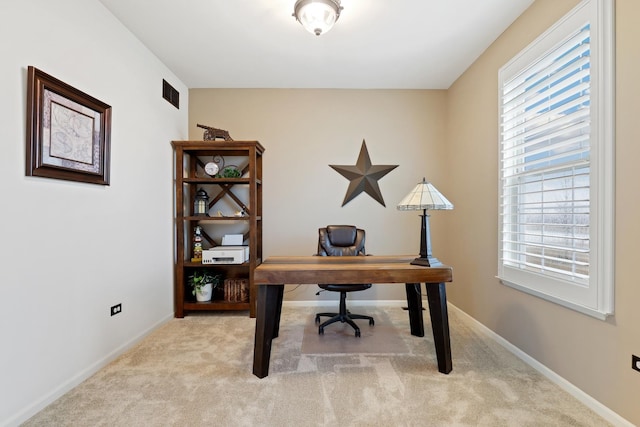 carpeted office space featuring baseboards, visible vents, and a wealth of natural light