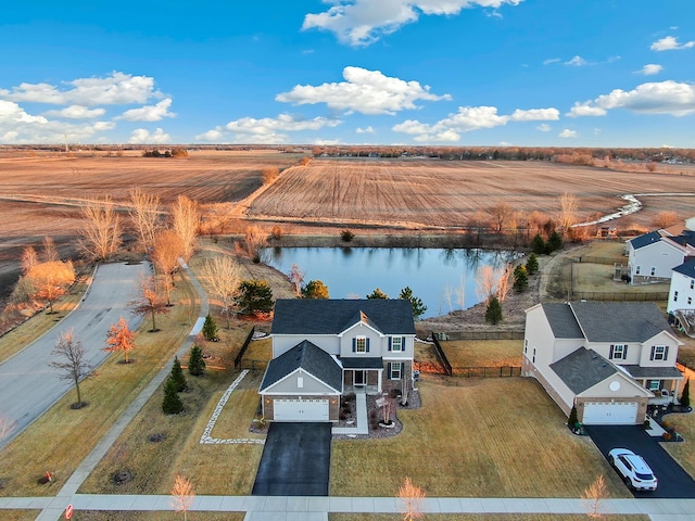 birds eye view of property with a water view and a rural view