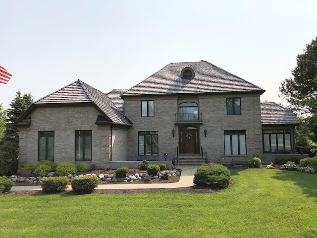 view of front of home with brick siding and a front yard