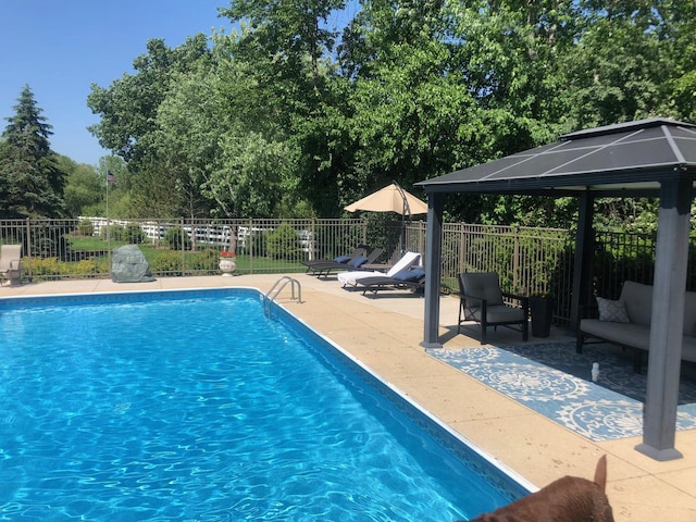 view of swimming pool with a fenced in pool, fence, a gazebo, and a patio