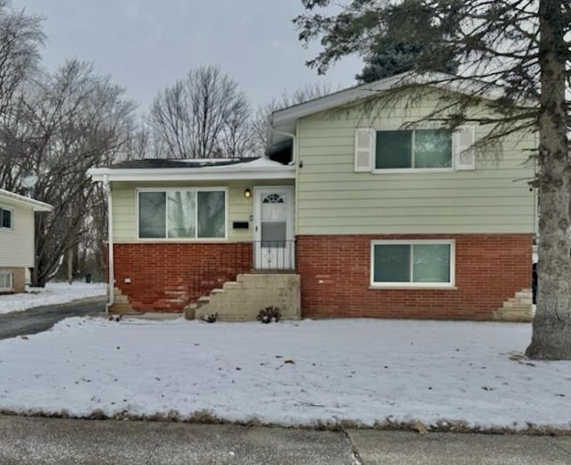 split level home featuring brick siding