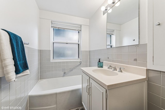 bathroom featuring a bathtub, tile walls, and vanity