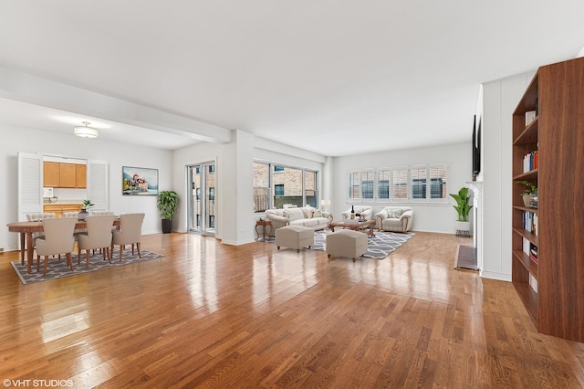 living area featuring light wood-type flooring and baseboards