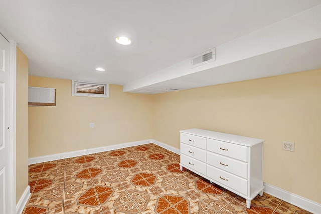 finished below grade area featuring recessed lighting, visible vents, and baseboards