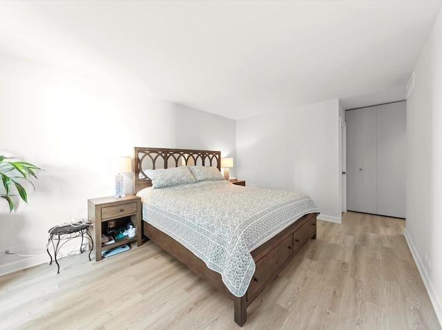 bedroom with light wood-style flooring and baseboards