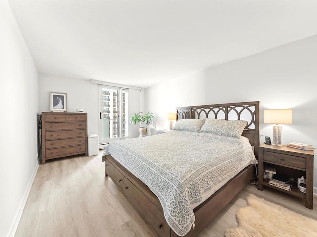 bedroom featuring light wood-style flooring and baseboards