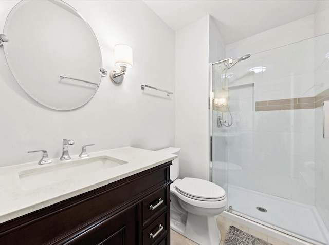 bathroom with toilet, tile patterned floors, a shower stall, and vanity