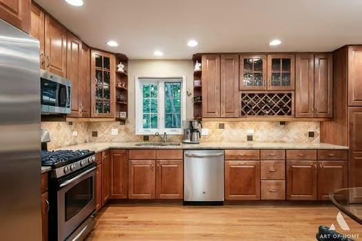 kitchen featuring stainless steel appliances, light countertops, glass insert cabinets, and open shelves