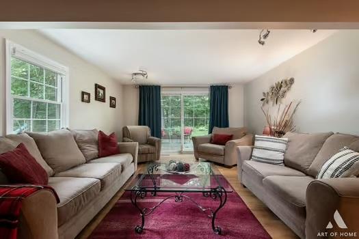 living area with a healthy amount of sunlight and wood finished floors