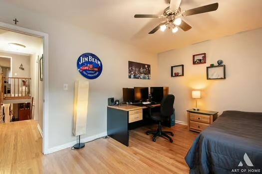 bedroom with ceiling fan, light wood-style flooring, and baseboards