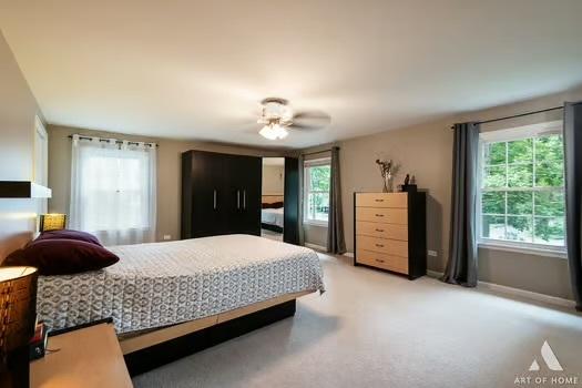 bedroom with baseboards and light colored carpet