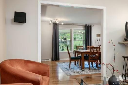 dining space with wood finished floors