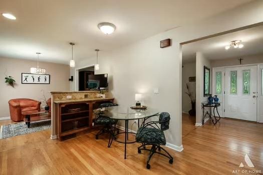 interior space featuring baseboards and light wood finished floors