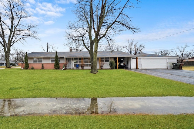 ranch-style home featuring aphalt driveway, an attached garage, brick siding, a chimney, and a front yard