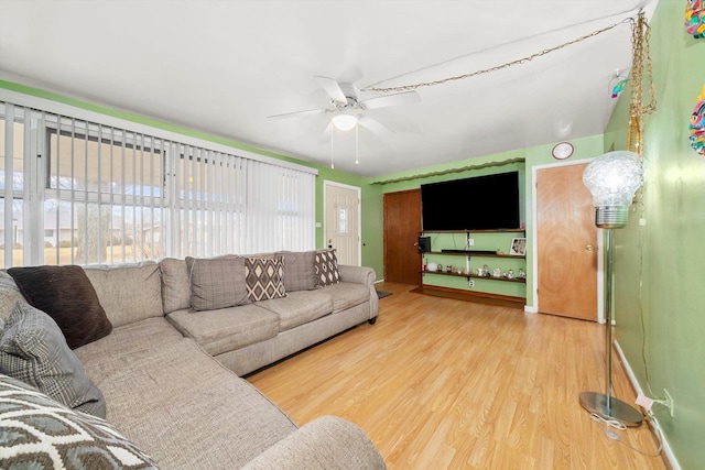 living room featuring ceiling fan and wood finished floors