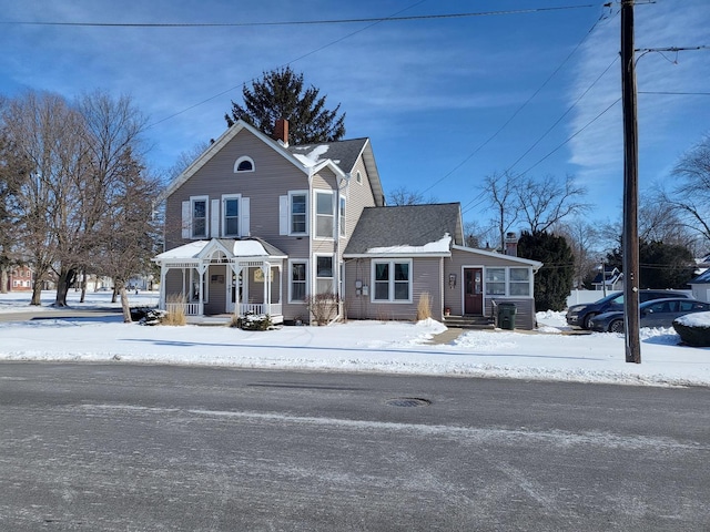 view of front of house featuring a chimney